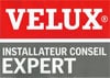 Logo VELUX avec la mention 'INSTALLATEUR CONSEIL EXPERT' en blanc sur fond gris, signalant un niveau de compétence certifié.